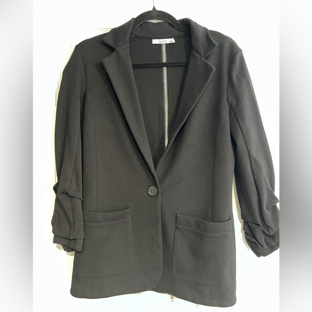 Black blazer with silver exposed zipper.